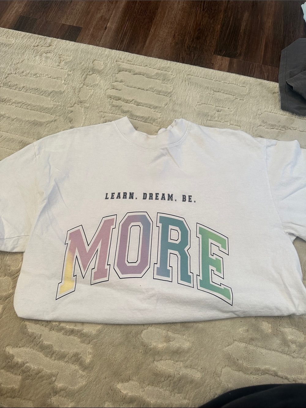 Alphalete White 'MORE' Graphic Tee - Pastel Rainbow Letters
